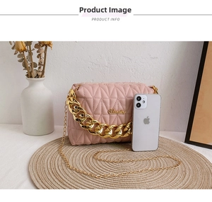 Pink quilted shoulder bag with gold chain strap and smartphone for size reference