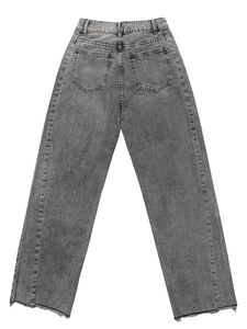 Detail van een grijs gewassen jeans met achterzakken en onafgewerkte zoom op wit decor