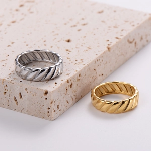 Minimalist 18K gold and silver stainless steel rings with diagonal tire tread texture