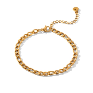 Macro detail of 18K gold stainless steel Figaro chain bracelet with lobster clasp