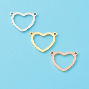 Detail of heart-shaped pendants in silver, gold, and rose gold with double loops