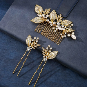 Detail of gold metal hair comb set with sparkling rhinestones and crystal flower patterns