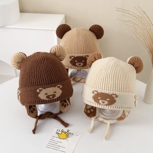 Detailed knit texture and earflap design of winter bear pattern hats for kids