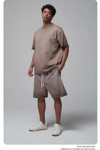 Detail of men's summer set with brown drop-shoulder t-shirt and drawstring shorts
