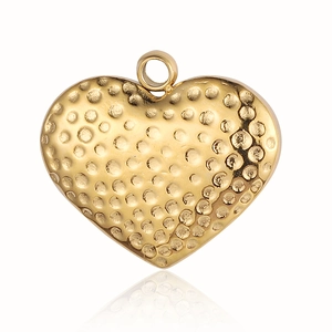 Macro shot of gold heart-shaped pendant featuring hammered metal texture and glossy finish
