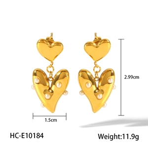 Macro view of 18k gold plated heart pearl earrings showing size and weight details