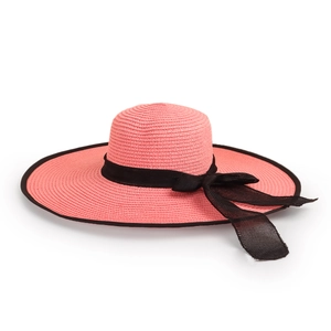 Close-up of pink straw hat with wide brim featuring a black ribbon bow detail