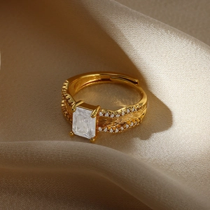 Detail of vintage gold ring featuring a rectangular zircon and fine metal textures on silk