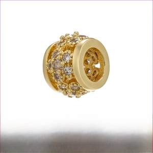 Detail showing 18K gold-plated brass bead with flower engraving and white zircon inlay