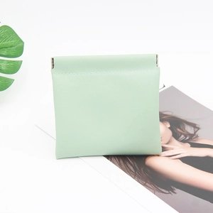 Close-up of mint green crocodile pattern small pouch with automatic metal spring closure