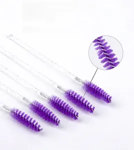 Macro detail of purple fiber disposable eyelash brushes with clear glitter crystal handles