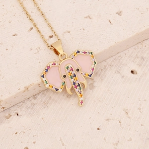 Golden elephant pendant necklace with pink enamel and colorful zircons on stone background
