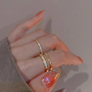 Close-up of gold plated double layer rings with cubic zirconia stones on model hand