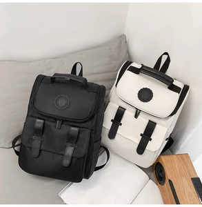 Detail showing high-density canvas backpacks in black and white with PU leather straps