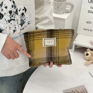 Detail of vintage plaid makeup bag with Pleasant Time label in ginger and brown check