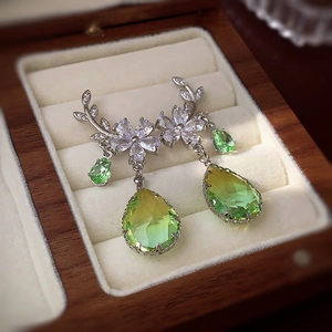Macro detail of leaf flower earrings with yellow-green gradient drop stones and zircon