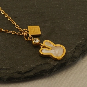 Golden titanium steel necklace with mother-of-pearl rabbit pendant on dark stone base
