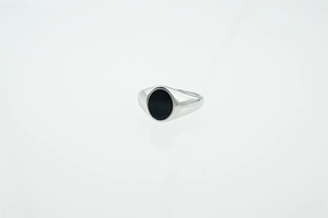 Macro detail of silver titanium steel ring featuring an oval black turquoise stone inlay