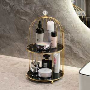 Double-tier gold iron makeup organizer with black marble shelves for vanity storage