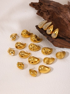 Detail of assorted 18K gold-plated teardrop and textured stud earrings with zircons