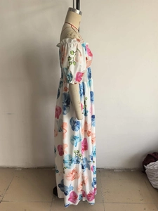 Détail de robe longue à fleurs colorées avec manches bouffantes dénudées sur mannequin