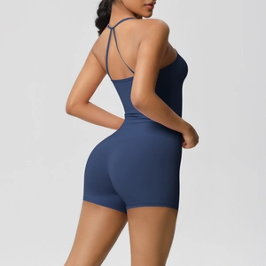 Detailed back view of dark blue yoga jumpsuit showing slim fit cross straps and open back