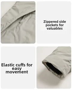 Detail einer grauen Winterjacke mit Reißverschlusstaschen und winddichten Bündchen