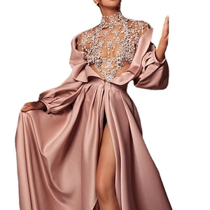Detailed view of pink evening gown featuring sequined lace bodice and high split skirt