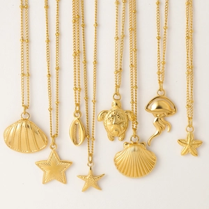 Detail of gold shell starfish turtle and jellyfish pendants on delicate beaded chains