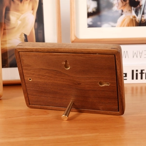 Premium walnut wood photo frame back view with dual mounting holes and metal stand