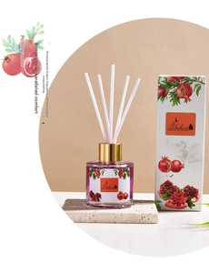 Close-up of pomegranate reed diffuser set with purple oil and white aroma sticks