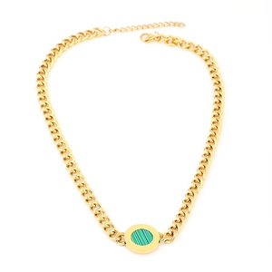 Detail of gold curb chain necklace featuring a green striped circular pendant charm