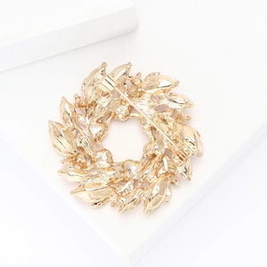 Detailed back view of gold wreath brooch showing secure metal pin clasp and texture