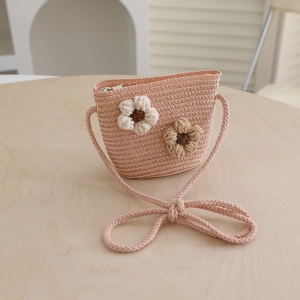 Detail of pink woven kids bag with handcrafted crochet flower decor and metal zipper
