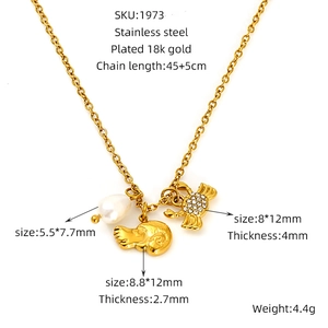 Detail view of gold stainless steel necklace with crab, snail charms and pearl pendants