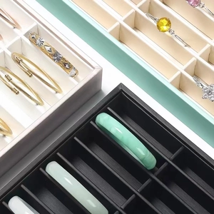 Velvet jewelry display trays for bracelets in beige, mint green, and black colors
