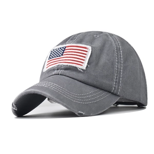 Detail shot of distressed grey cotton baseball cap with American flag embroidery and worn edges