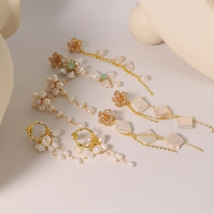 Elegant collection of vintage baroque pearl earrings with golden metal tassel accents