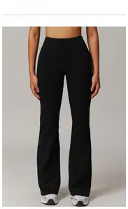 Front view of premium black high-waisted flared yoga pants on model in studio