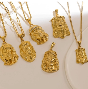Detailed view of gold plated Jesus head pendants with variety of chain styles and CZ stones