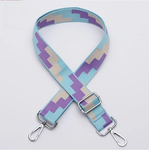 Close-up of adjustable blue and purple geometric woven shoulder strap with silver hooks