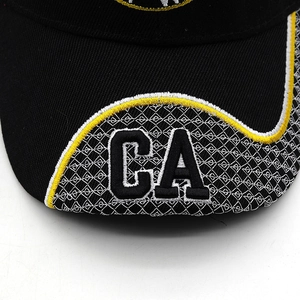 Close-up of yellow wavy embroidery and CA lettering on a black flat brim baseball cap