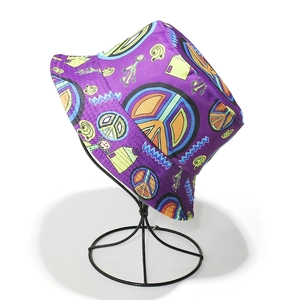 Purple bucket hat with peace signs and colorful pop art prints in a full-print design