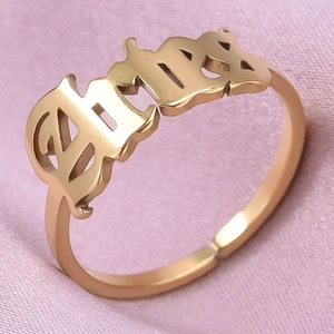 Macro shot of rose gold 304 stainless steel adjustable ring with Gothic Baby lettering