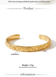 Macro view of gold celestial pattern bangle with sun and moon motifs inlaid with zircon