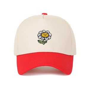 Close-up of color-block baseball cap with sunflower smile embroidery and red brim