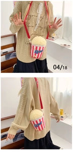 Detailed view of creative popcorn plush crossbody bag with red and white stripes and embroidery