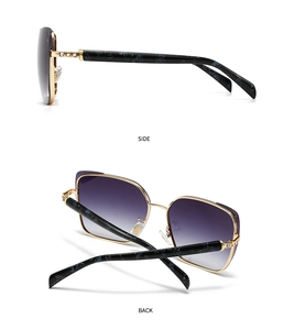 Detail view of gold metal frames with purple gradient lenses and marble textured temples