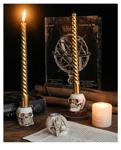 Detailed view of skull candle holders with skeletal texture for Halloween decor