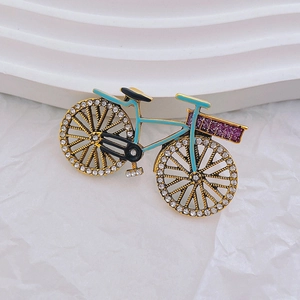 Exquisite gold bicycle brooch with light blue enamel and sparkling rhinestone wheels